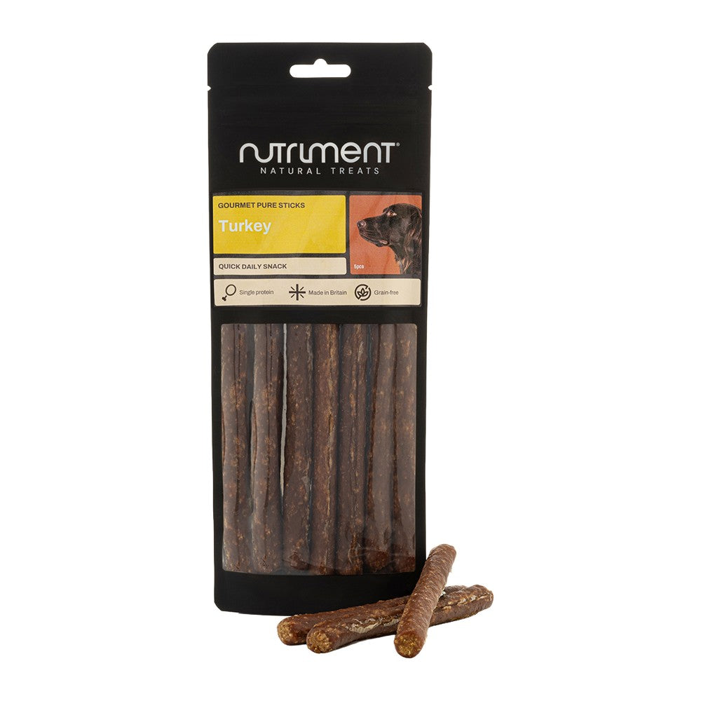 Nutriment Gourmet Pure Sticks Kalkon 100g, smal svart påse med gul etikett och godispinnar framför, mot vit bakgrund